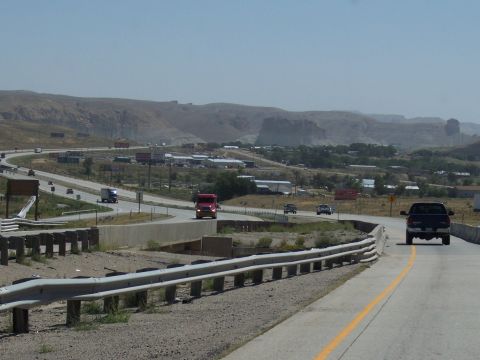 1972 Ford Ranchero - A wide highway curves through a landscape with a small town visible in the distance.