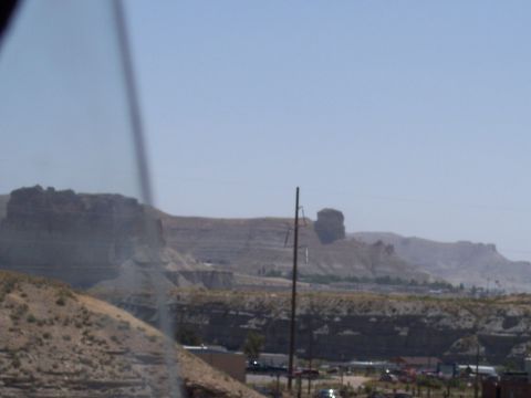 1972 Ford Ranchero - A wide view of a desert landscape layered rock formations and a small town in the distance.