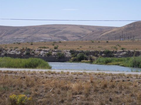 1972 Ford Ranchero - A wide landscape shot shows dry hills bordering a river on a sunny day.