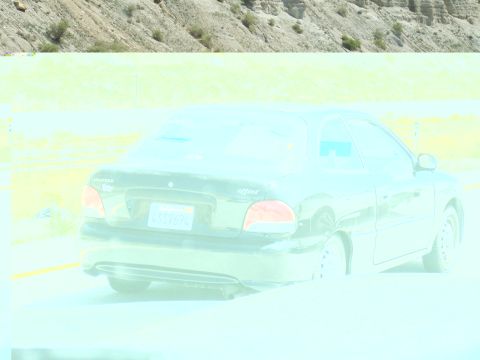 1972 Ford Ranchero - A black Hyundai Accent is seen from the rear on a road with a dry, rocky hillside behind it.