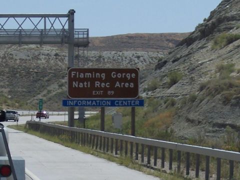 1972 Ford Ranchero - A sign indicates the entrance to Flaming Gorge National Recreation Area, with vehicles passing by on the highway.