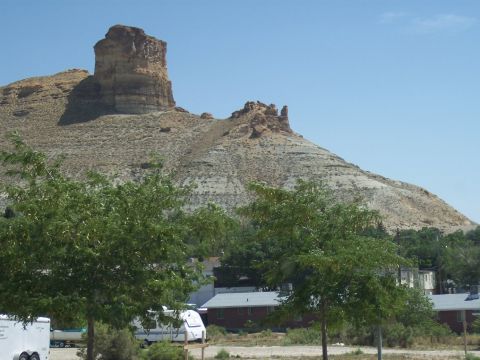 1972 Ford Ranchero - A landscape scene with trailers and buildings in front of a prominent rock formation under a clear blue sky.