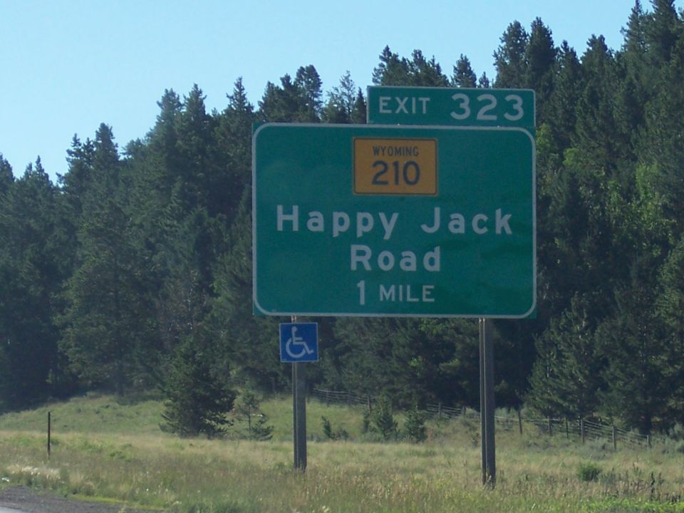 Green highway sign for Exit 323, Wyoming 210, Happy Jack Road, 1 mile
