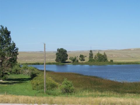 1972 Ford Ranchero - A wide view of a lake and surrounding landscape under a clear blue sky.