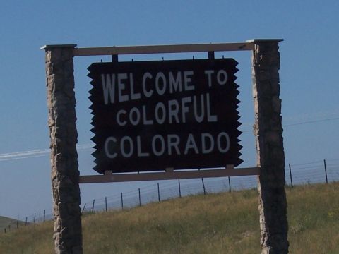 1972 Ford Ranchero - A sign welcomes visitors to Colorado, set against a clear blue sky and grassy hillside.