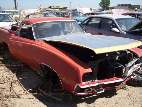 1972 Ford Ranchero - Junkyard scene with a damaged 1970 Ford Ranchero as the main subject.
