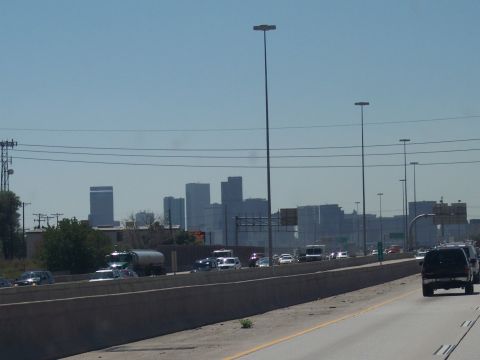 1972 Ford Ranchero - Traffic moves along a highway with a distant city skyline visible.