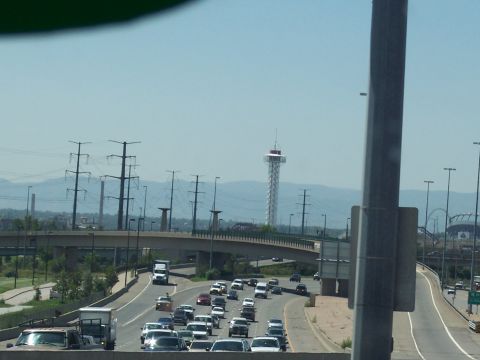 1972 Ford Ranchero - A busy highway scene with multiple lanes of traffic and a distinctive tower visible in the distance.