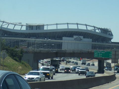 1972 Ford Ranchero - Traffic moves along a highway with Invesco Field stadium visible in the background.