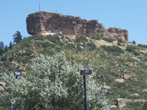 1972 Ford Ranchero - A prominent rock formation overlooks a vegetated hillside, with trees in the foreground.