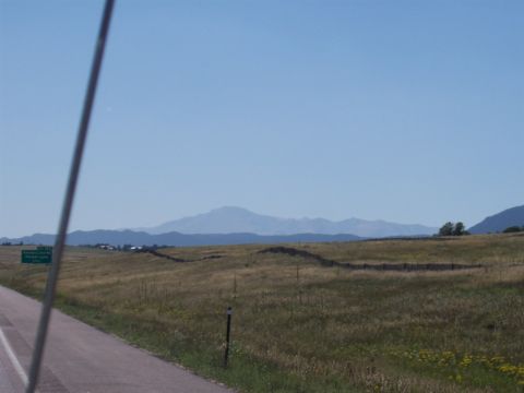 1972 Ford Ranchero - A vast landscape unfolds with rolling hills and distant mountains, seen from the roadside.