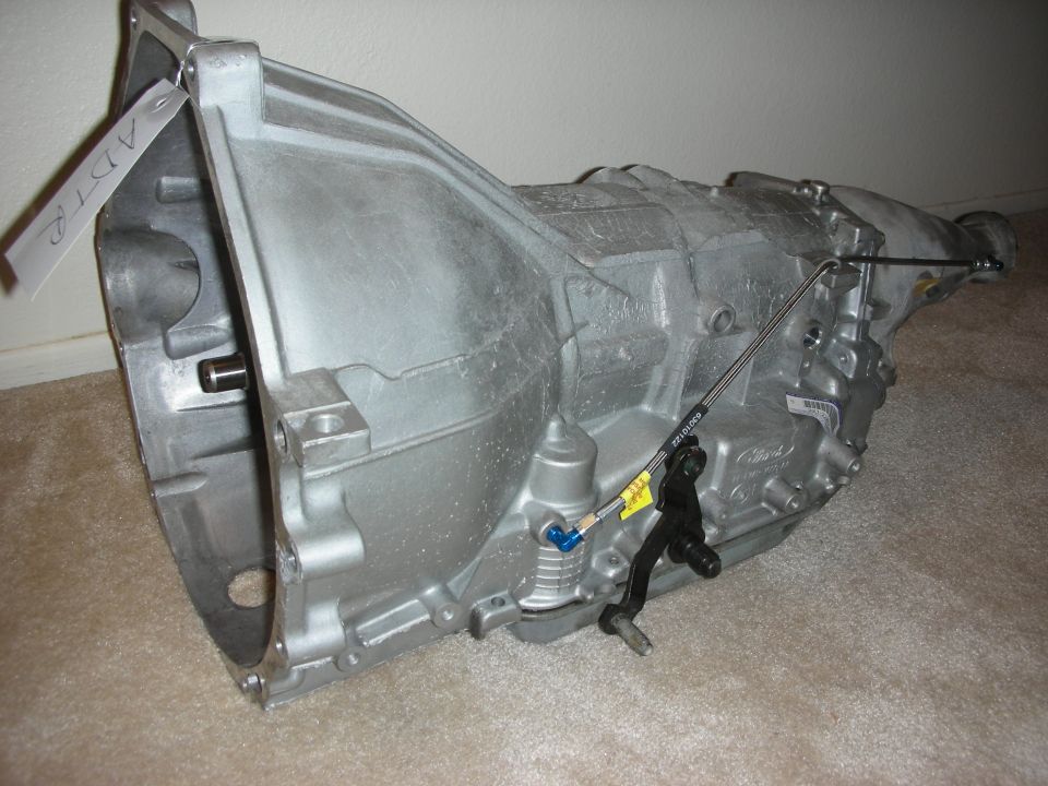 Transmission assembly with shift linkage and a tag reading 'ADTR'