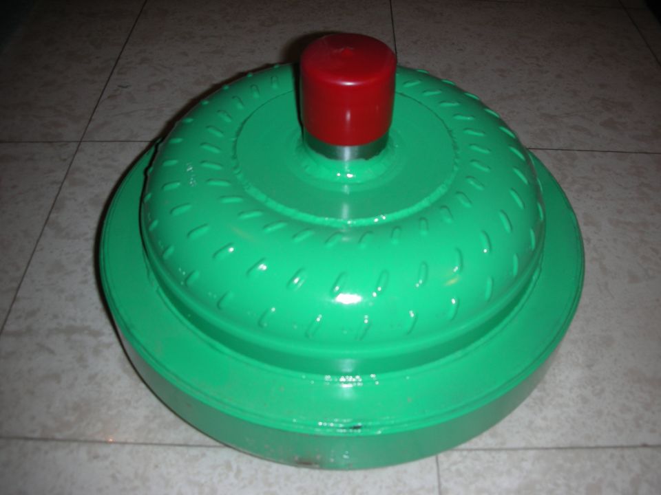 Green torque converter with a red protective cap on top