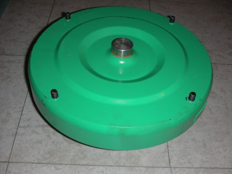 1992 Ford Crown Victoria - A green torque converter is shown from a top-down perspective, with a central shaft and four bolts around the perimeter.