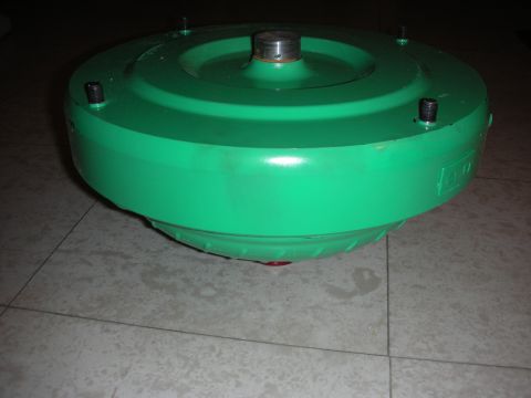1992 Ford Crown Victoria - A green torque converter, a component of an automatic transmission, is shown in this image.