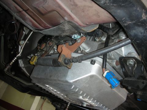 1992 Ford Crown Victoria - Close-up of the underside of a vehicle, focusing on the transmission and associated parts.