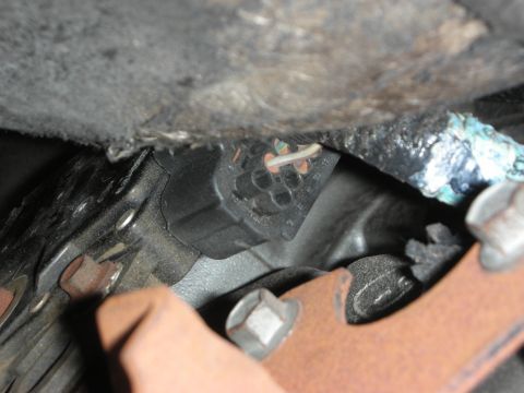 1992 Ford Crown Victoria - An electrical connector with frayed wires is visible in this close-up mechanical view.
