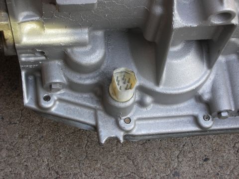 1992 Ford Crown Victoria - Close-up of a transmission housing, showing the electrical connector and mounting bolts.