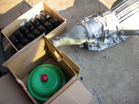1992 Ford Crown Victoria - Automatic transmission and torque converter parts are laid out on a concrete surface.