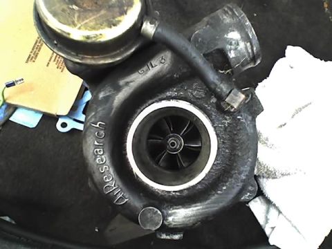 1991 Ford Mustang - A close-up view of an Air Research turbocharger, showing its internal components and some visible markings.