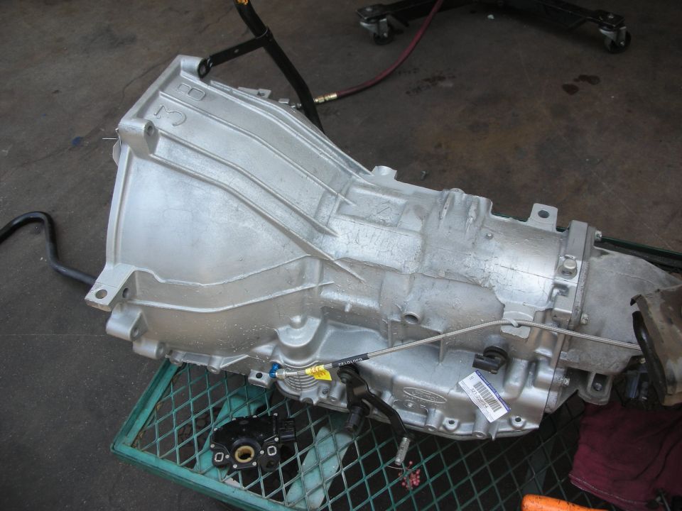 Silver transmission with Ford logo visible