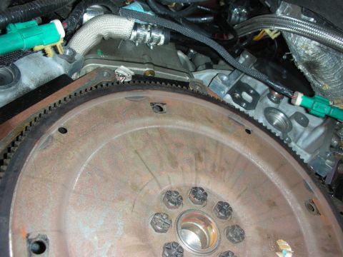 1992 Ford Crown Victoria - Close-up view of an engine's transmission and flywheel assembly, showing mechanical components and wiring.