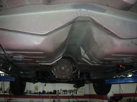 1992 Ford Crown Victoria - The underbody of a vehicle is shown, focusing on the transmission and exhaust components.