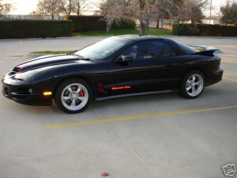 2002 Pontiac Trans Am - A black 2002 Pontiac Trans Am is parked in a lot, viewed from the front three-quarter angle.