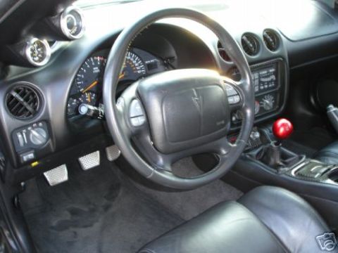 2002 Pontiac Trans Am - Interior view of a 2002 Pontiac Trans Am, the dashboard, steering wheel, and manual shifter.