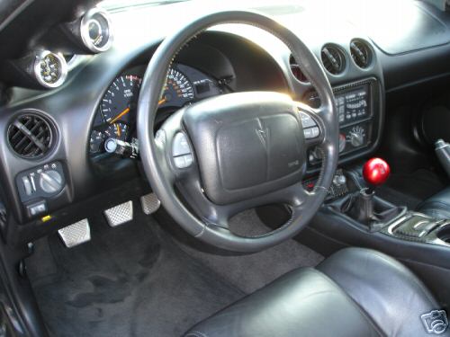2002 Pontiac Trans Am interior showing dashboard, steering wheel, and shifter