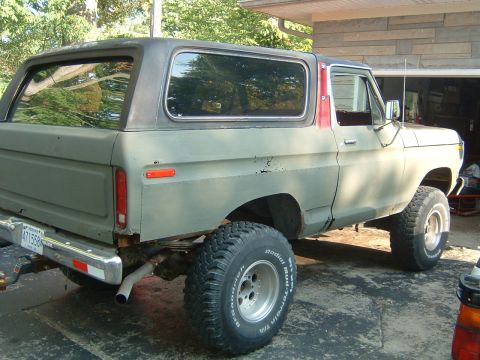 1979 Ford Bronco - This 1978 Ford Bronco is parked outside a garage, showing its side profile and lifted stance.