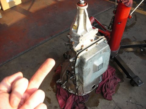 1992 Ford Crown Victoria - A transmission part is shown resting on red shop towels on a concrete floor.