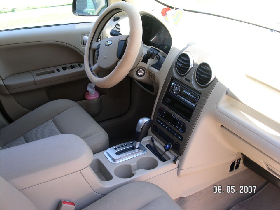 Tan cloth car interior, Ford steering wheel, Pioneer stereo, automatic shifter