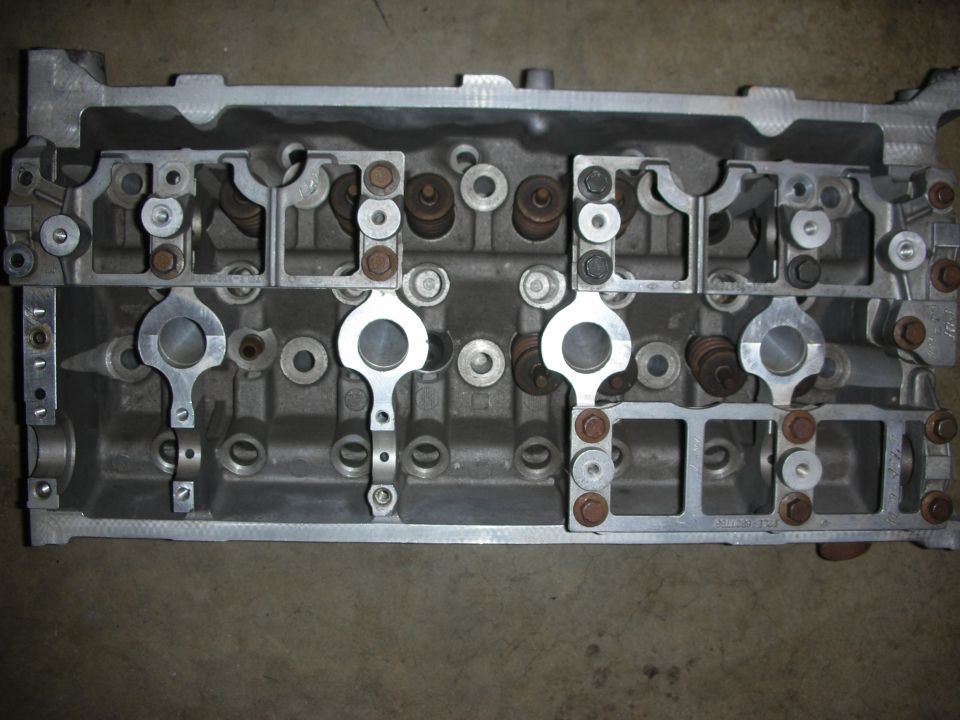 Close-up of an engine cylinder head with valves and rockers visible