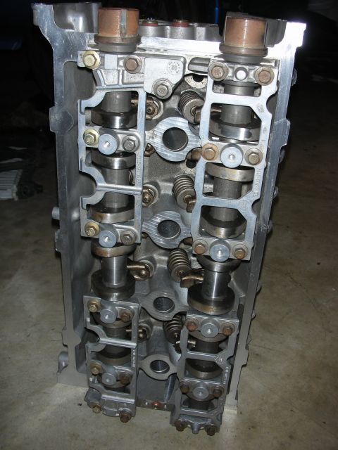 1998 Ford Crown Victoria - This is a close-up view of an engine's cylinder head, revealing its internal components like camshafts and valves.