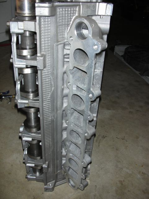1998 Ford Crown Victoria - Close-up of an aluminum engine cylinder head, showing intake manifold ports and camshafts.