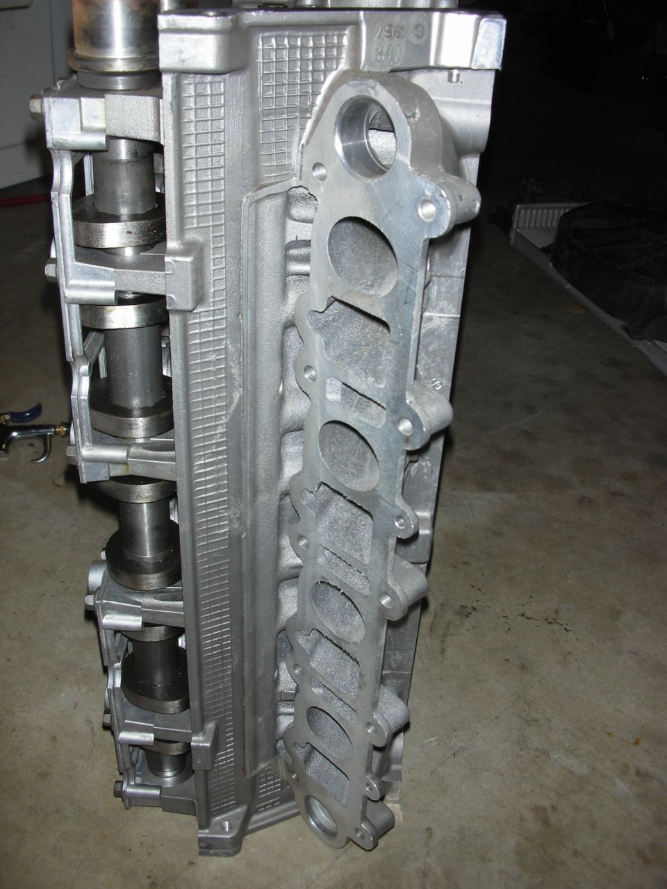 Aluminum engine cylinder head with intake manifold ports visible