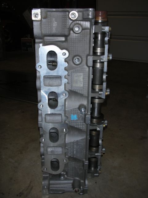 1998 Ford Crown Victoria - Engine cylinder head with intake ports and camshafts shown.