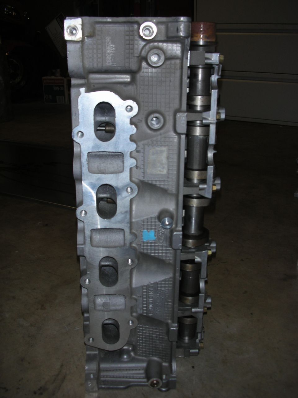 Engine cylinder head with intake ports visible