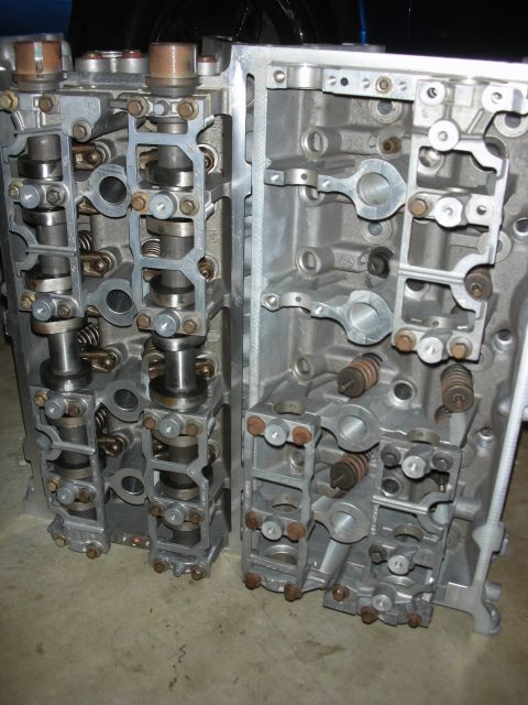 1998 Ford Crown Victoria - Close-up of two engine cylinder heads, showing internal components like camshafts and valve springs.