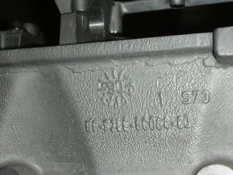 1998 Ford Crown Victoria - Close-up of a metal engine component showing casting marks and a part number.