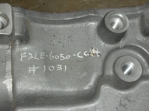 1998 Ford Crown Victoria - Close-up of an engine part showing casting numbers F2LE-6050-CC4 and #1031, along with other markings.