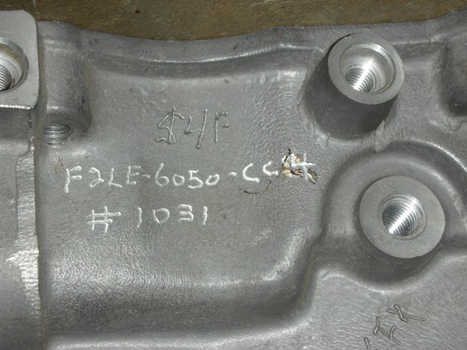 Engine part with casting numbers F2LE-6050-CC4 and #1031