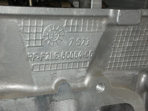 1998 Ford Crown Victoria - Close-up of an engine part casting showing a date code and part number.