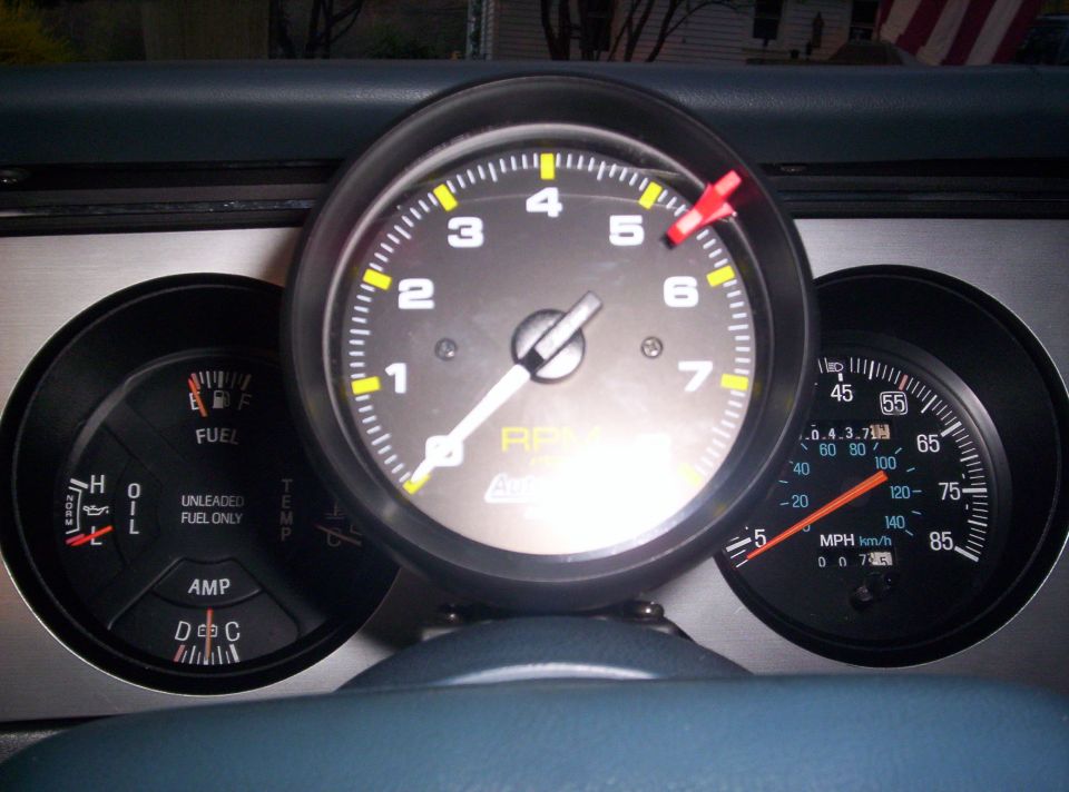 Dash gauge cluster with center Auto Meter tachometer, 85 MPH speedometer, and fuel/oil/amp gauges