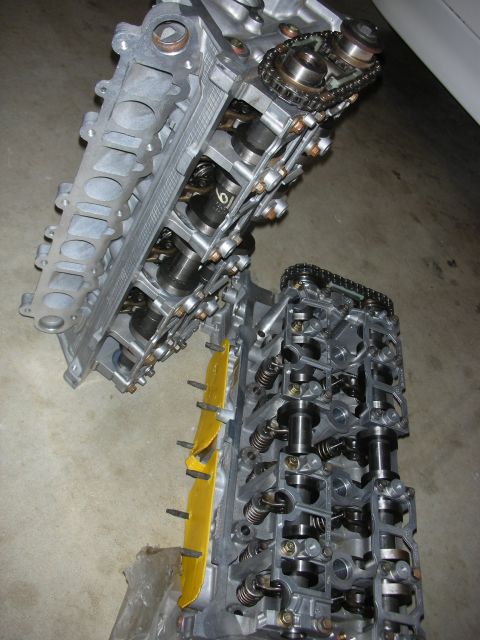 1998 Ford Crown Victoria - Disassembled engine cylinder heads showing internal components and timing chain mechanisms.