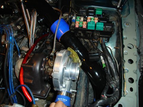1995 Mazda MX-6 - Custom turbocharger installation in an engine bay, showing various engine components and wiring.