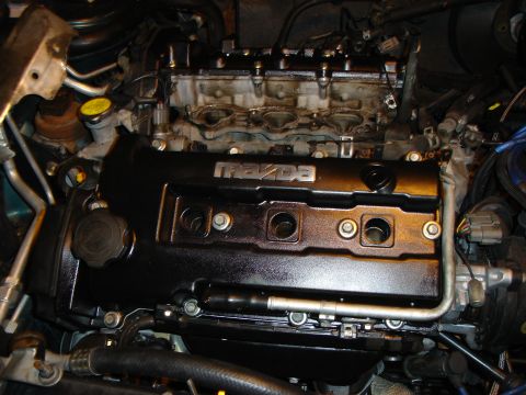 1995 Mazda MX-6 - Close-up view of a Mazda engine, likely undergoing maintenance or modification.