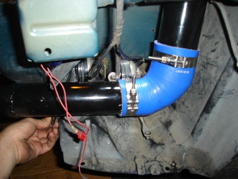 1995 Mazda MX-6 - Close-up of turbo piping installation with blue silicone hose and metal clamps.