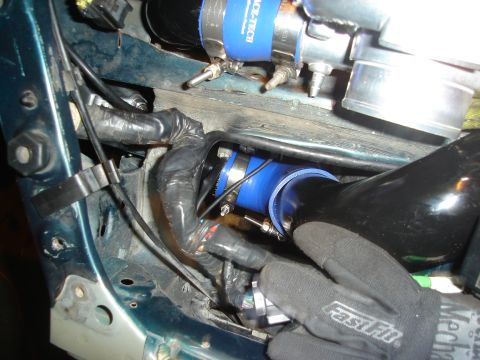 1995 Mazda MX-6 - Close-up view of engine bay modifications, including turbocharger piping and wiring.